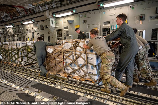 Members of the North Carolina Air National Guard push a hurricane relief pallet into position on a C-17 Globemaster III for delivery to Western North Carolina