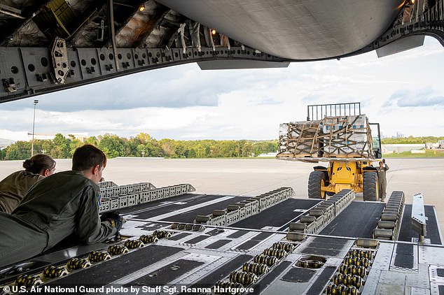 Pictured: A C-17 is loaded before a hurricane relief package is delivered