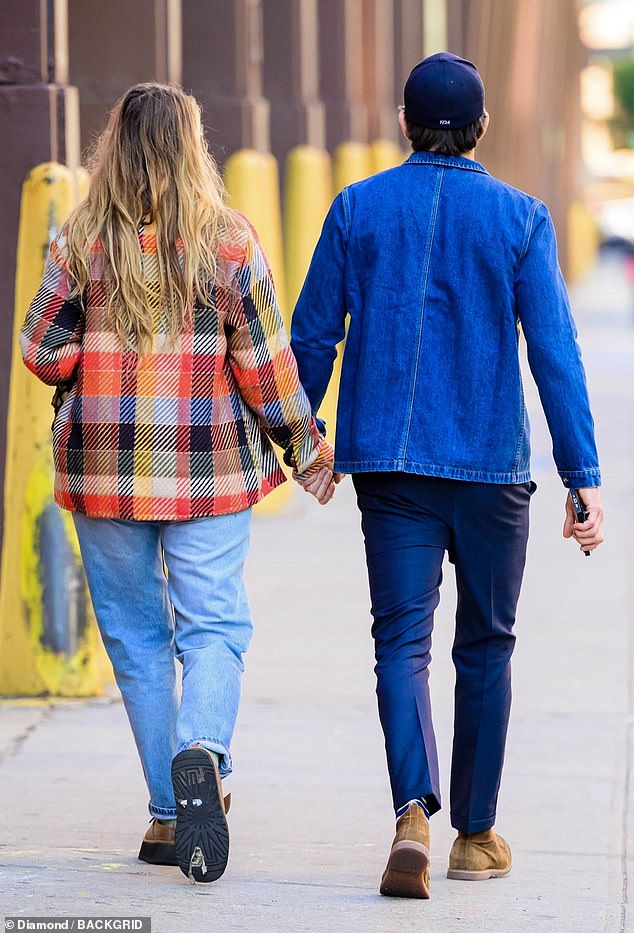 Lively wore an orange, navy and yellow patterned jacket over a low-cut brown sweater and light wash jeans