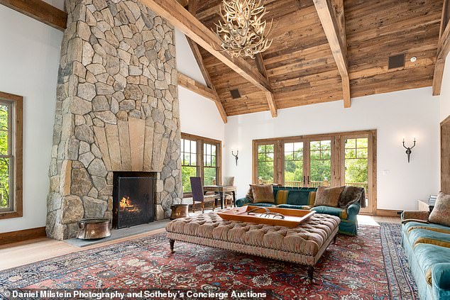 A living room comes complete with a massive stone fireplace