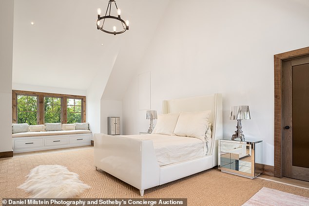 One of the smaller bedrooms has a sleek appearance with bright white walls