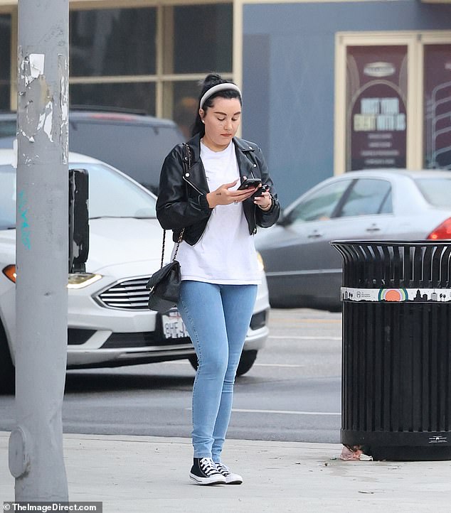 The She's the Man star, 38, wore a simple white T-shirt and skinny jeans with a chic cropped black leather jacket and high-top black Converse