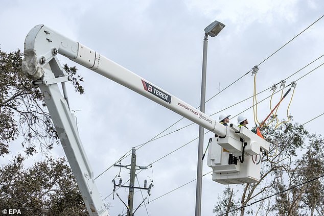 Utility workers repair power lines after Hurricane Milton in Englewood, Florida on October 11