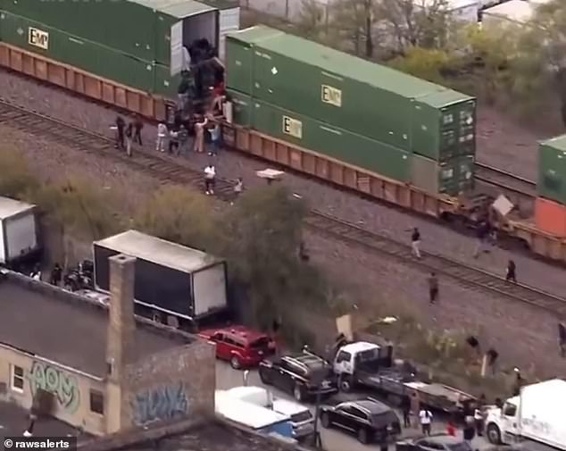 The men then hand the load to other people who carry it along the track to waiting trucks