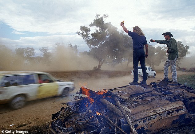 Revheads did burnouts in half-disused cars on the track and then set them on fire when they were done - with some fans testing their bravado by running into the flaming wreckage