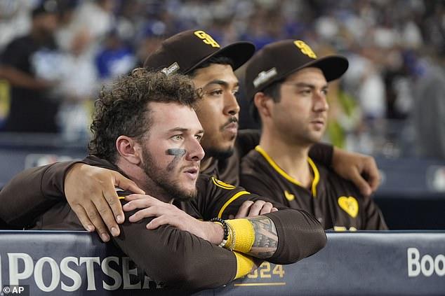 San Diego Padres center fielder Jackson Merrill, left, looks on next to relief pitcher Jeremiah Estrada, center, and catcher Kyle Higashioka after the loss to the Dodgers in LA