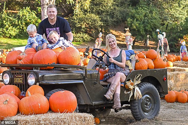 At one point during their afternoon outing, the couple gathered the children in front of a photo of them sitting on an old U.S. Army Jeep, which was decorated with an array of pumpkins, with Montag in the driver's seat.