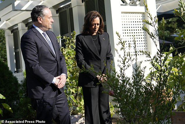 Harris, right, and Second Gentleman Doug Emhoff stand after planting a memorial tree on the grounds of the vice president's residence in Washington on Monday