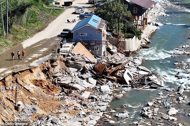 Destroyed and damaged buildings in the aftermath of Hurricane Helene's flooding on October 8, 2024 in Bat Cave, North Carolina