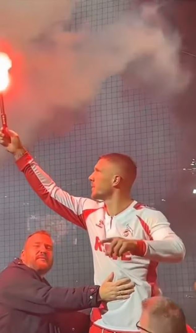 Among the more than 50,000 fans, Podolski waved a flare and celebrated like one of them