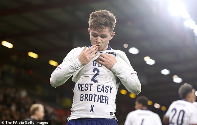 McAtee pictured celebrating his second goal by unveiling a tribute to the late George Baldock