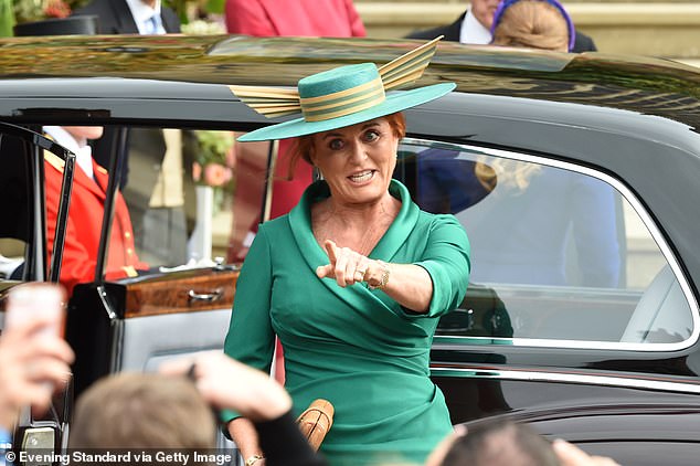 The bride's mother, Sarah Ferguson, sees people she knows when she arrives at the wedding