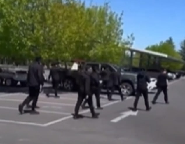 The figures, dressed from head to toe in black, were heard chanting white supremacist slogans before marching to the city's war memorial.