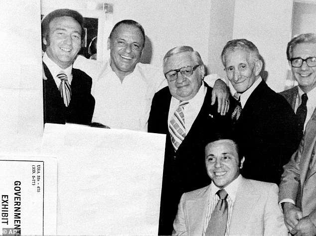 Posing with mob friends in his dressing room in 1976. From left: Gregory De Palma, Sinatra, Thomas Marson, Carlo Gambino, Jimmy 'The Weasel' Fratianno, and front, Richard 'Nerves' Fusco. The photo was entered into evidence during the trial of De Palma and Fusco for fraud