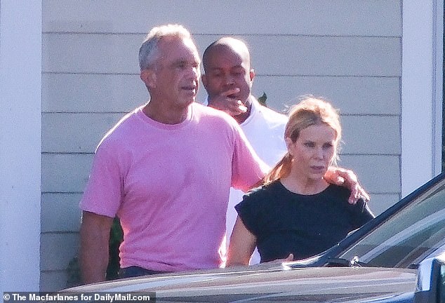 RFK Jr put his arm around his wife and held her tight before the two got into a car and headed to a nearby gym