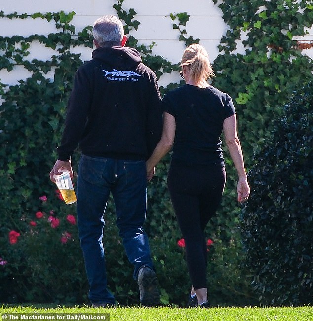 Exclusive photos from DailyMail.com show the couple holding hands at the Kennedy Compound in Hyannis Harbor as they present a united front ahead of the funeral