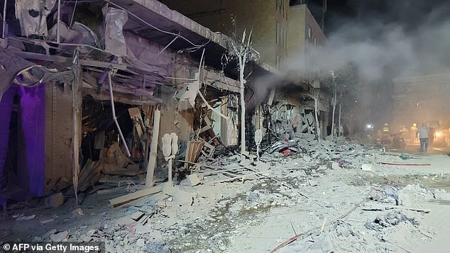 A rescuer searches for survivors in the southern Lebanese city of Nabatiye