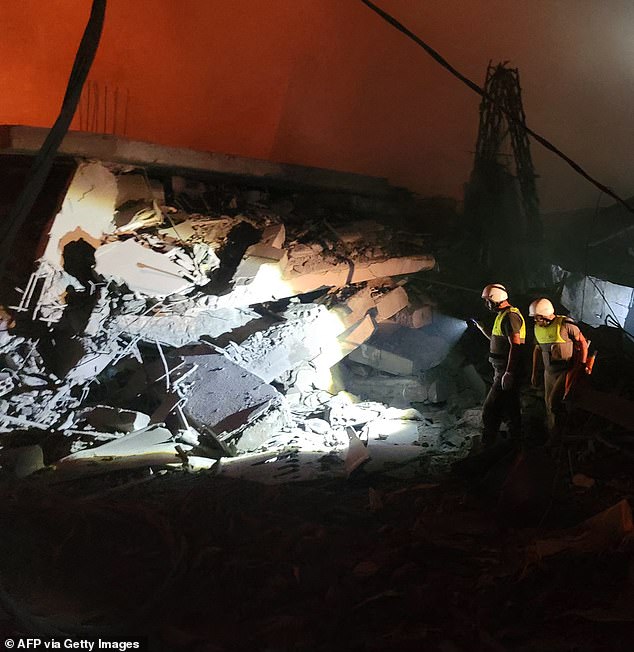 Rescuers begin their search for survivors in the wreckage