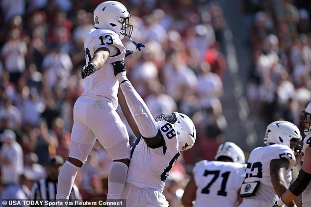 Nittany Lions running back Kaytron Allen (13) is lifted into the air by offensive lineman Anthony Donkoh (68) after scoring a touchdown on Saturday