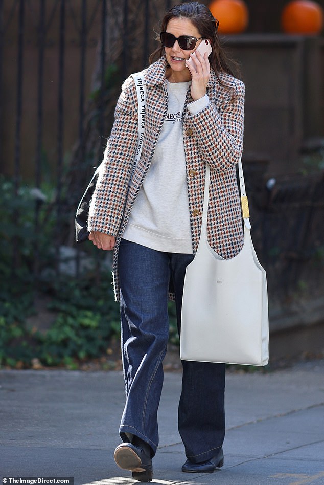 As she stepped out into the city this weekend, Katie, 45, was bundled up in a fashionable multi-coloured houndstooth coat