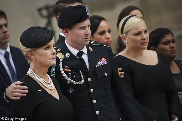 John McCain's son Jimmy McCain (center) recently switched his party registration from Independent to Democratic and announced he is voting for Harris