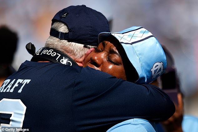 North Carolina Tar Heels head coach Mack Brown (left) embraces September Craft, mother of North Carolina wide receiver Tylee Craft, whose death was revealed Saturday