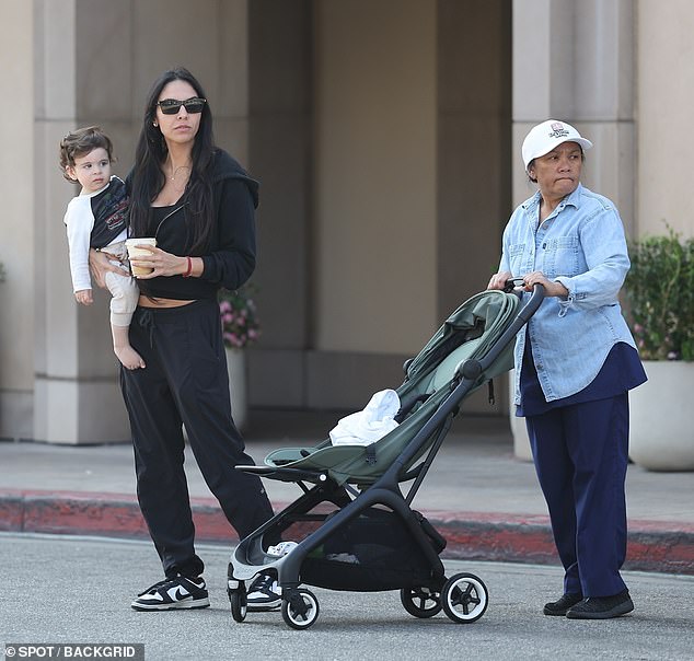 Dressed in sweatpants, hoodie and sneakers, the film producer got a smoothie while at the coffee shop, then lifted her son into her arms and started walking with her nanny