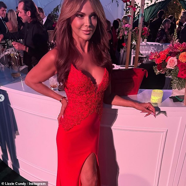 Lizzie looked sensational as she showed off her ample cleavage in a low-cut red dress