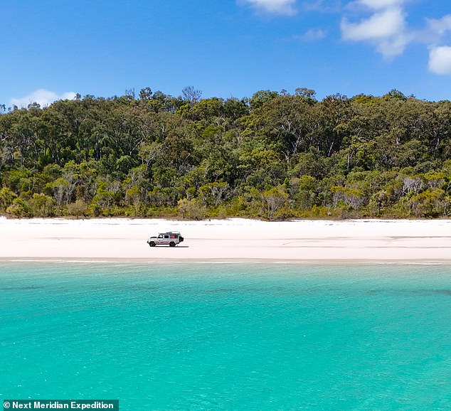 The couple are pictured here driving along a beach on K'gari Island in Australia