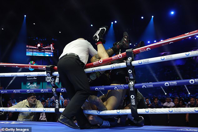 Whittaker and Cameron tumbled over the top rope in the fifth round of their fight