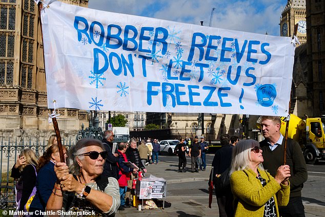 A banner at the demonstration in London outside Parliament against Labour's decision to trial the winter fuel payment