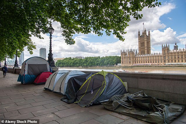 Pictured: People sleeping rough in tents next to the River Thames, opposite the Palace of Westminster on June 8, 2022