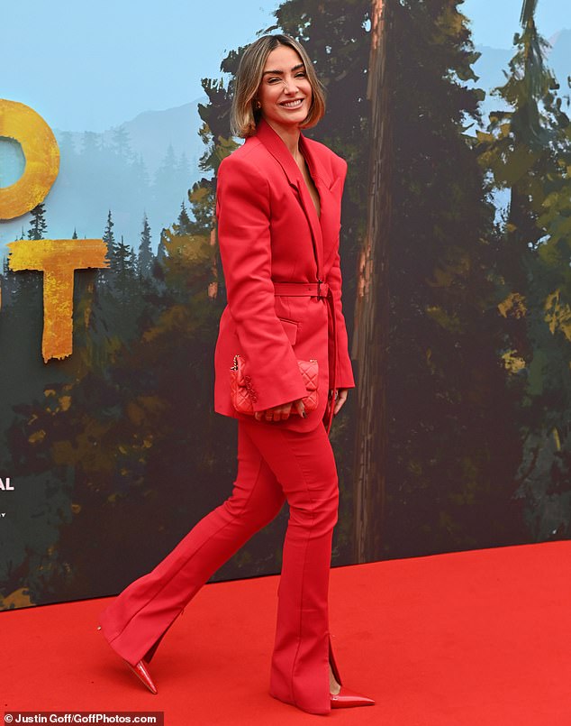 The former Saturdays singer opted for matching skinny trousers and boosted her figure with a pair of sky-high red stilettos