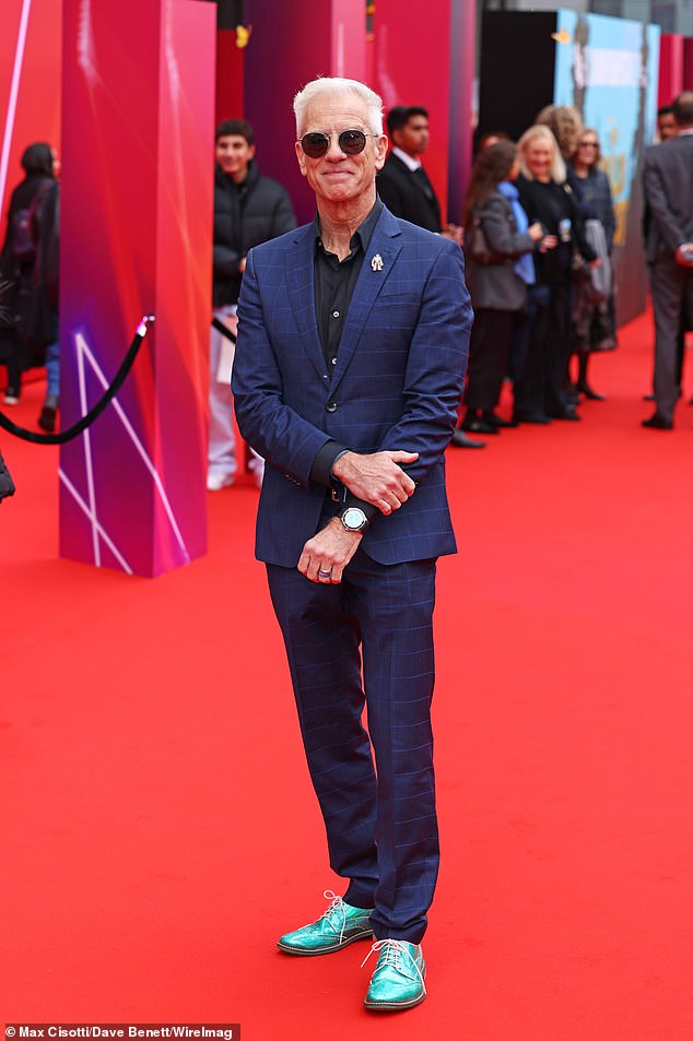 Director Chris Saunders smiled as he posed on the red carpet