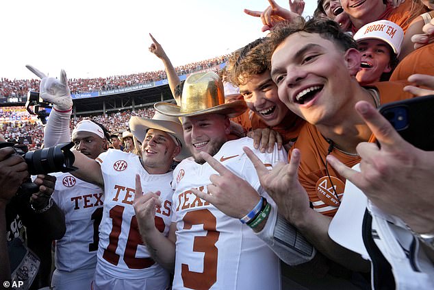 Texas quarterback Quinn Ewers celebrates with teammates and fans after the latest win