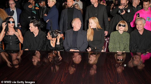 They sat in the front row next to Salma's husband François-Henri Pinault, center. Katy is pictured far right talking to Bill Skarsgård, second from left, while Kyle MacLachlan, far right, sat next to Anna Wintour, second from right