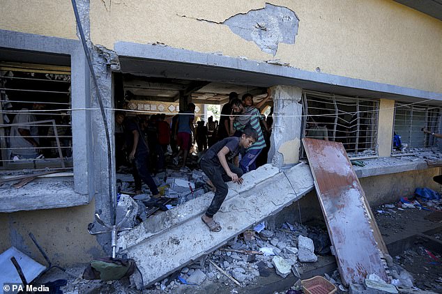 Palestinians search for the bodies of relatives killed in an Israeli bombardment in Deir al-Balah