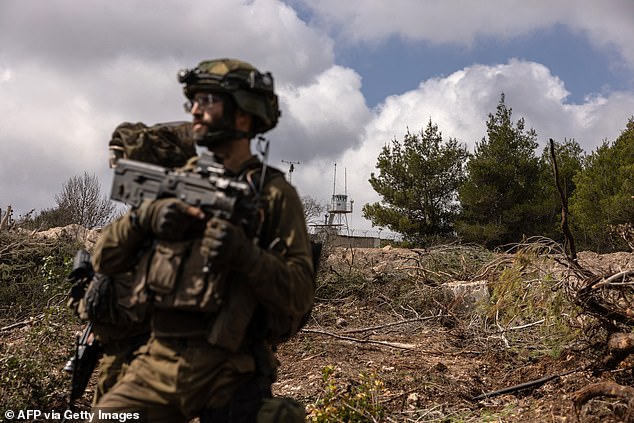 Israeli troops patrol near a United Nations Interim Force In Lebanon (UNIFIL) base in the Naqoura region of southern Lebanon, near the border