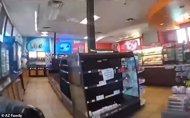 Further footage taken inside the store shows a third Phoenix police officer interviewing the Circle K store clerks who summoned them in the first place