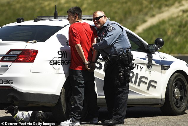 A sheriff's deputy arrests a suspect for attempted carjacking from a truck in Denver, Colorado