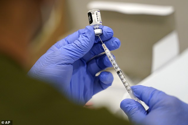 After receiving the Pfizer Covid booster, Mr Lowe developed numbness in his face and pain around his body, which has not subsided in the three years since. In the photo: A syringe is filled with the Pfizer Covid vaccine in October 2021