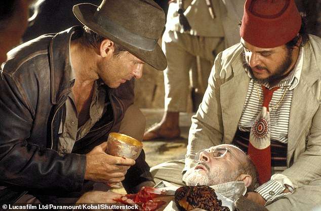 Pictured is Indiana Jones (Harrison Ford) holding the Holy Grail in the 1989 film 'Indiana Jones and the Last Crusade' starring Henry Jones Sr. (Sean Connery) and Sallah (John Rhys-Davies)