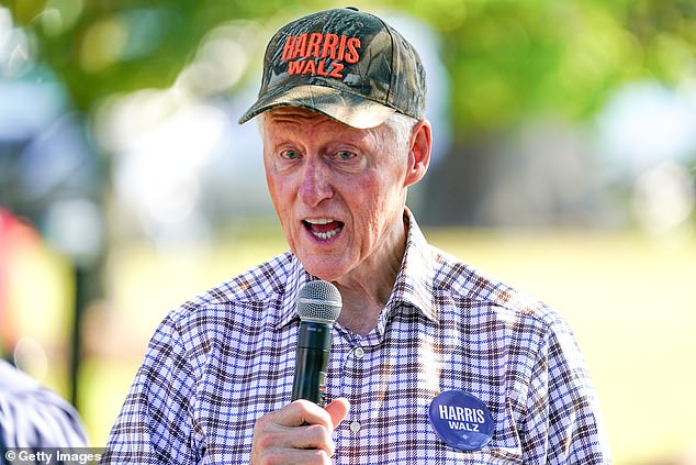 Clinton, 78, wears a Harris-Walz camouflage cap while campaigning for vice president in Fort Valley, Georgia, on Sunday, October 13