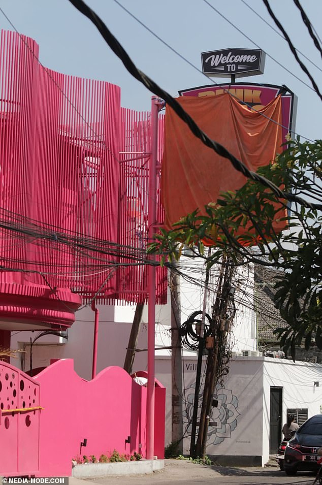 Bali police have closed the Pink Palace 'sensual spa and relaxation centre' and covered the sign with a cover over the venue's neon sign, which features a rooster and the words 'happy coq, happy life'.