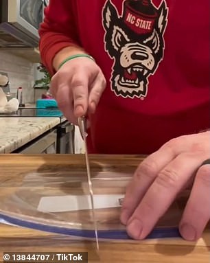 The hack uses a hot knife heated over a gas stove to cut and seal one Ziploc bag into two half-size functional Ziploc bags