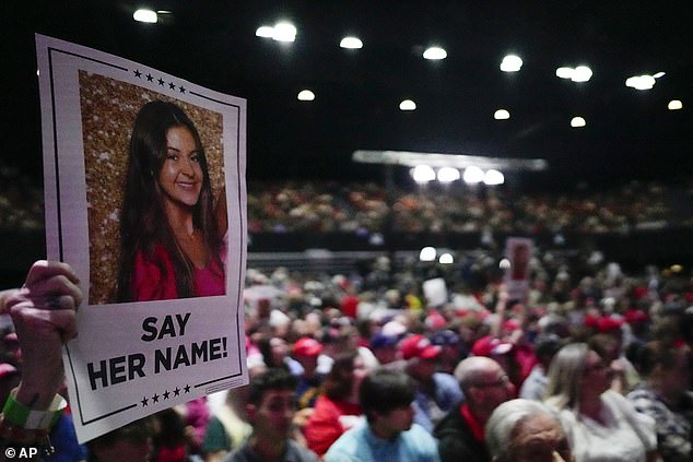 A supporter holds a sign with a photo of Laken Riley before Republican presidential candidate, former President Donald Trump, speaks during a campaign rally, Saturday, March 9, 2024