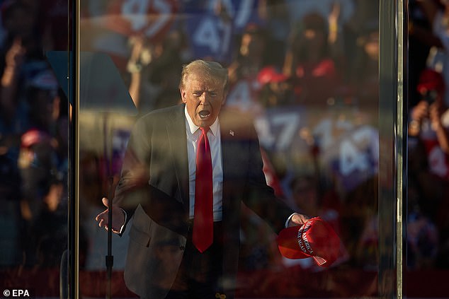 Trump has been speaking behind bulletproof glass at his outdoor rallies since the July 13 assassination attempt on him in Butler, Pennsylvania. Pictured: Trump at his rally in Coachella, California on October 12, 2024