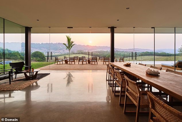 Highlights include the floor-to-ceiling windows that provide stunning views of the surrounding hills. (Pictured)