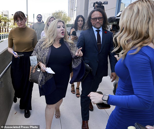 Former Las Vegas City Councilwoman Michele Fiore, center, refuses to answer questions after reading a statement to the news media outside the Lloyd George US Courthouse in Las Vegas