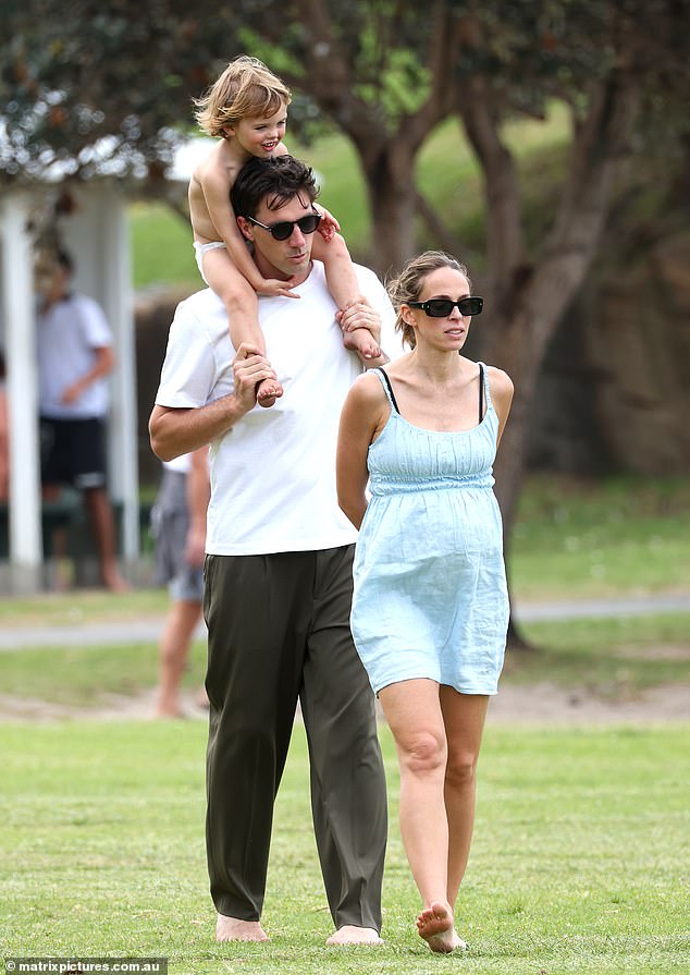 The cricket superstar is pictured giving his son Albie a ride on his shoulders while his wife Becky shows off her growing baby bump